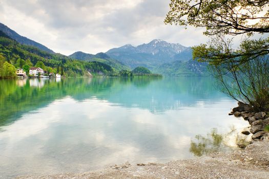 Mountains lake and low mountains with snowy peaks in water mirror. Lake in National Park.