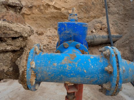 Detail of fittings, 250mm and 150mm gate valves, reduction joint members in drink water system. Repairing of piping in excavation pit. Extreme kind of corrosion, metal corroded texture.