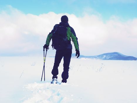 Snowshoes walk. Winter trekking in fresh powder snow with snowshoes.