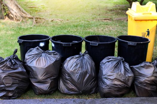 waste, garbage in black bag and bin, pile of bin trash junk dirt and garbage bag many in garden public park, plastic waste