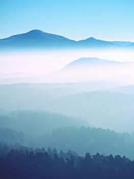 View on a big rounded hill from plane, beautiful fantastic view. Fantastic dreamy sunrise, mountain above misty valley. Tourist resort.