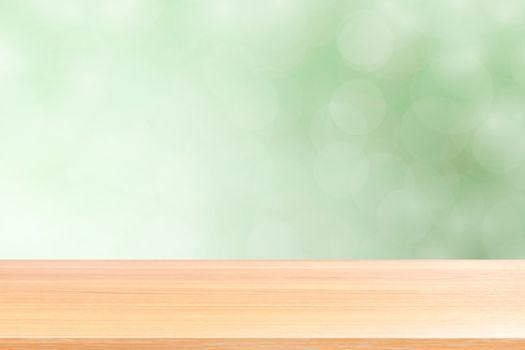 empty wood table floors on blurred bokeh soft green gradient background, wooden plank empty on green bokeh colorful light shade, colorful bokeh lights gradient soft for banner advertising products