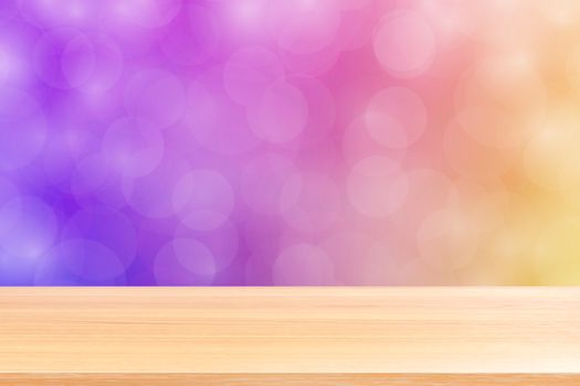 empty wood table floor on blurred bokeh soft purple gradient background, wooden plank empty on purple bokeh colorful light shade, colorful bokeh lights gradient soft for banner advertising products