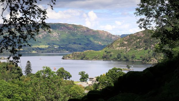 A view across Ullswater lake in the English Lake District National Park.  The lake is viewed close to the village of Glenridding.