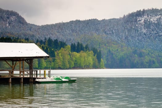 Wooden roof for trip holiday paddle boats. Holiday resort on the shores of beautiful Alpine lake