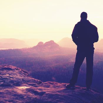 Silhouette of Young Confident and Powerful Man Standing with Hands on Hips, Late Day Sun with Copy Space