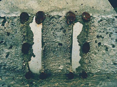 Steel or iron rod in concrete mass, detail on construction site. Concrete railway ties stored for reconstruction of old railway station. 