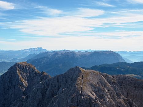 Contours of sharp mountains,  side by side increased from morning high humidity. Far view to daybreak horizon