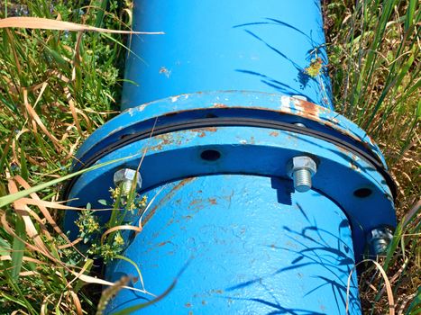 Repaired big drink water pipes joined with new blue flanges and silver screws 