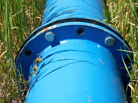 Repaired big drink water pipes joined with new blue flanges and silver screws 