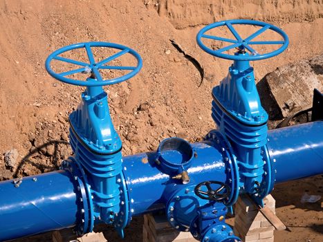 Gate valves underground, water pipeline valve on a blue pipeline after complete reconstruction. 
