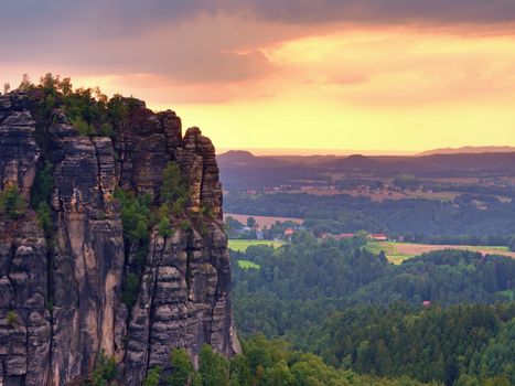  Sharp sandstone cliffs above deep valley. Popular climbers resort. Rocks sticking up from forest lanscape to sky