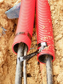 Wire in HDPE and protectivep tube. Building of lines of metallic and fiber optic cables, construction of communication optical network connection. Excavation of trench by hand or mechanized excavator and installation.