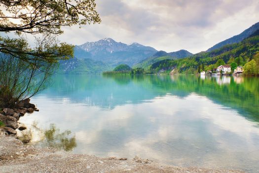 Mountains lake and low mountains with snowy peaks in water mirror. Lake in National Park.