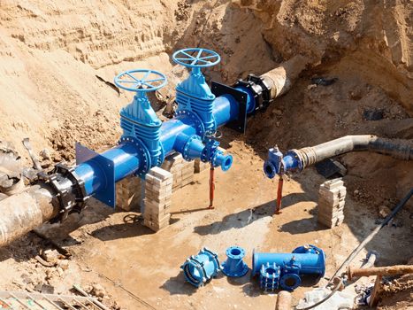 Drink Water Factory. Various pipelines, valve gates and metal pipes. Toned image. Repairing of pipeline underground.