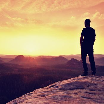 Silhouette of Confident and Powerful Man Standing with Hands on Hips, Late Day Sun with Copy Space