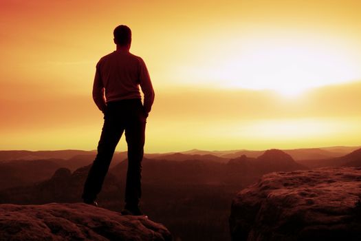 Silhouette of Young Confident and Powerful Man Standing with Hands on Hips, Late Day Sun with Copy Space