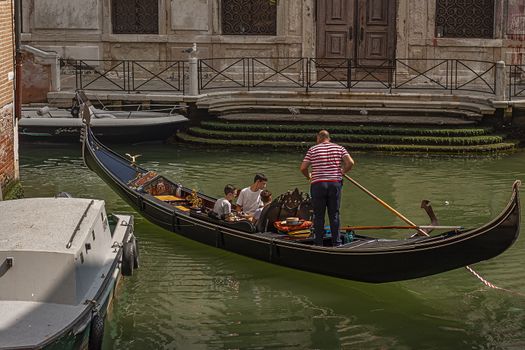 VENICE, ITALY 2 JULY 2020: Gondolier in Venice canal