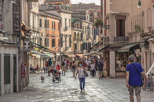 VENICE, ITALY 2 JULY 2020: Tourists walk in Venice street