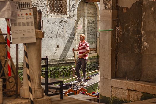 VENICE, ITALY 2 JULY 2020: Gondolier in Venice canal