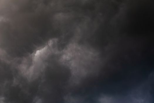 gray incoming storm clouds dark closeup backdrop, captured on 100 mm telephoto lens