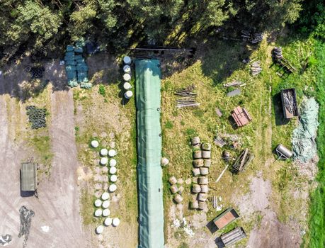 Detailed view from the air of a storage place for a farm, with silage, hay and straw, aerial view, made with drone