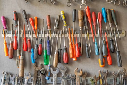 large set of old wrenches and screwdriver in the DIY workshop.