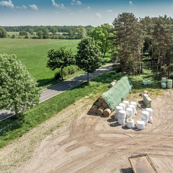 Detailed view from the air of a storage place for a farm, with silage, hay and straw, aerial view, made with drone