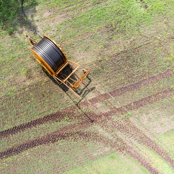 Aerial view of a huge hose cart used by the farmers to irrigate the arable land, Germany near Gifhorn, made with drone