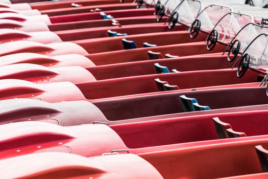 Abstract photo of red pedal boats moored at the jetty on a lake in Hannover, Germany