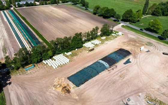 Aerial view of a farm camp, diagonal view of a large silage heap, made with drone