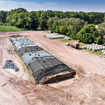 Aerial view of a farm camp, diagonal view of a large silage heap, made with drone