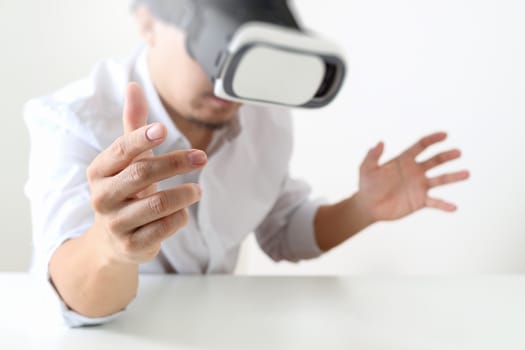 businessman wearing virtual reality goggles in modern office with mobile phone using with VR headset 