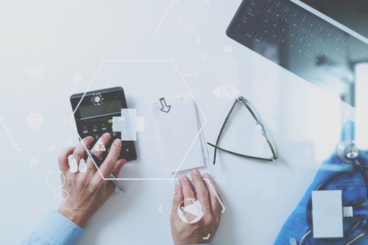 top view of Healthcare costs and fees concept.Hand of smart doctor used a calculator for medical costs in modern hospital with VR icon diagram