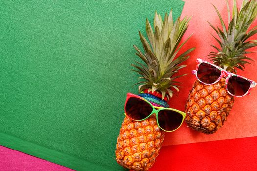 Summer and Holiday concept.Hipster Pineapple Fashion Accessories and Fruits on colorful background