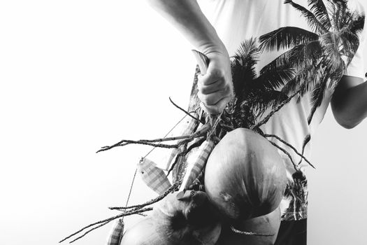 Summer and holiday fashion concept.Man Wearing palm trees graphics on T-shirt and holding cluster of coconuts with items on white background