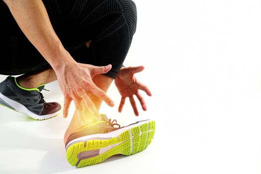 Runner sportsman holding ankle in pain with Broken twisted joint running sport injury and Athletic man touching foot due to sprain on white background