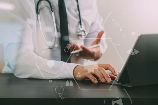 close up of smart medical doctor working with digital tablet computer and stylus pen and stethoscope on dark wooden desk with virtual icon diagram