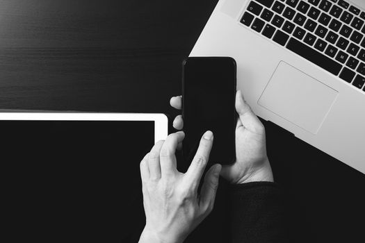 cyber security internet and networking concept.Businessman hand working with VR screen padlock icon mobile phone on laptop computer,black and white