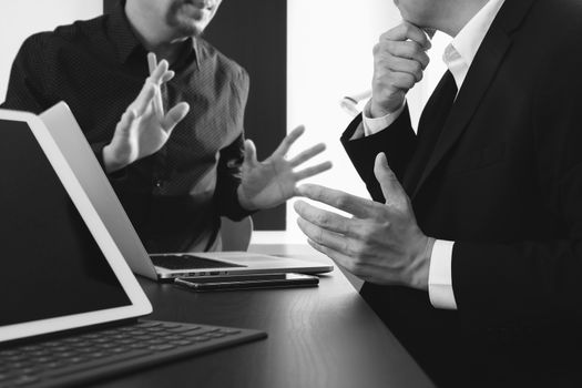 co working team meeting concept,businessman using smart phone and digital tablet and laptop computer in modern office,black and white