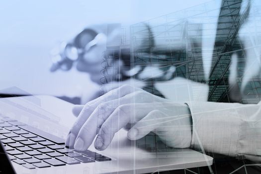 close up of smart medical doctor working with laptop computer and mobile phone and stethoscope on dark wooden desk with London city exposure