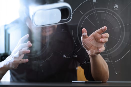 businessman wearing virtual reality goggles in modern office with mobile phone using with VR headset with screen icon diagram