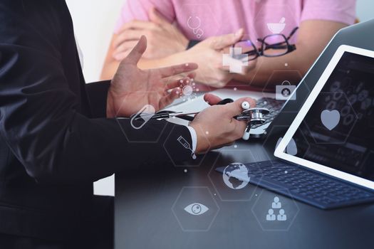 Medical co working concept,Doctor working with smart phone and digital tablet and laptop computer to meeting his team in modern office at hospital with virtual icon diagram