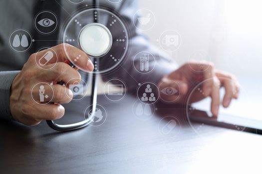 close up of smart medical doctor working with stethoscope and mobile phone on dark wooden desk in modern hospital with virtual reality icon diagram 