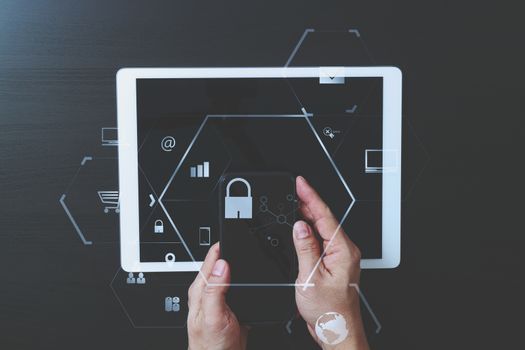 cyber security internet and networking concept.Businessman hand working with VR screen padlock icon on mobile phone and digital tablet computer