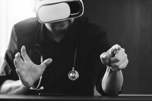 businessman wearing virtual reality goggles in modern office with mobile phone using with VR headset,black and white