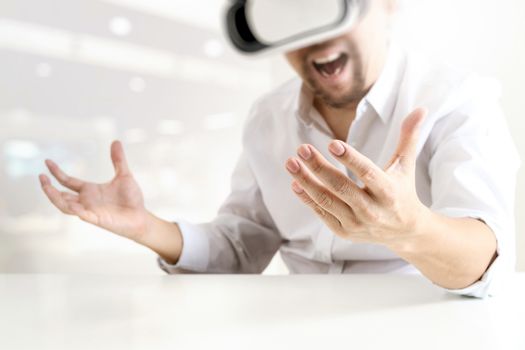 businessman wearing virtual reality goggles in modern office with Smartphone using with VR headset