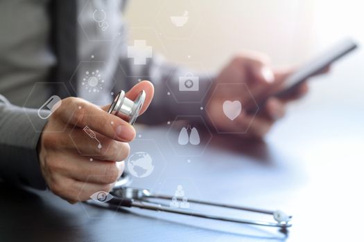 close up of smart medical doctor working with stethoscope and mobile phone on dark wooden desk in modern hospital with virtual reality icon diagram 