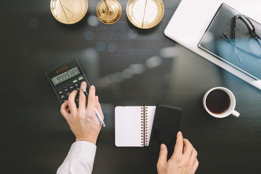 justice and law concept.businessman or lawyer or accountant working on accounts using a calculator and laptop computer and documents in modern office