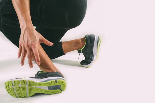 Runner sportsman holding ankle in pain with Broken twisted joint running sport injury and Athletic man touching foot due to sprain on white background